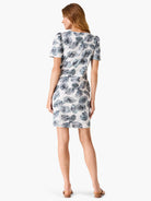Off-white t-shirt dress with teal and gray leaf print. Short sleeves, knee-length.