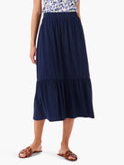 Navy blue tiered midi skirt with elastic waistband.  The skirt has a slightly A-line shape.