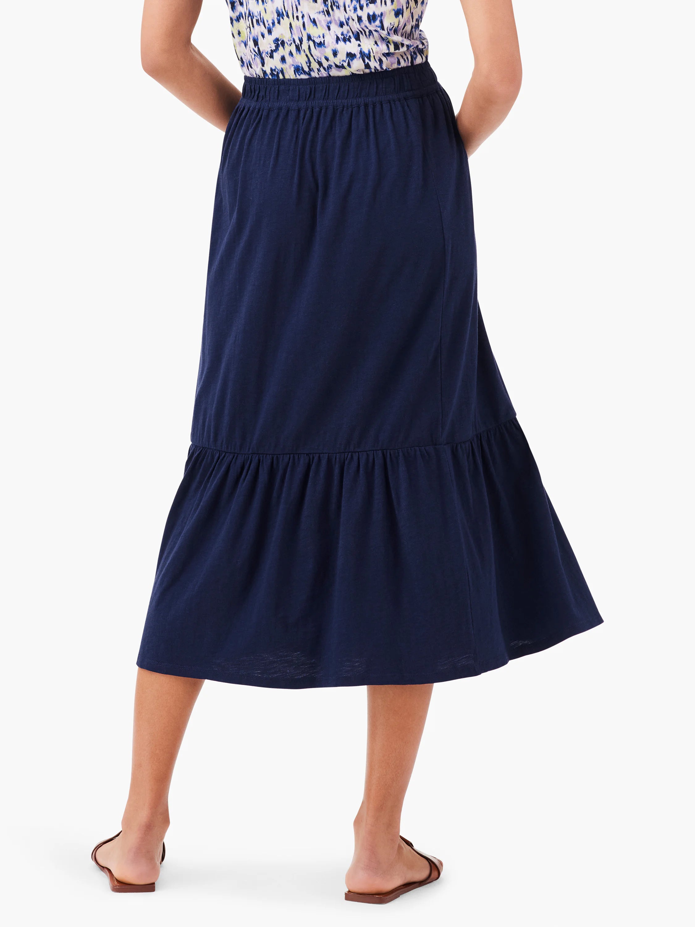 Navy blue tiered midi skirt with elastic waistband.  The skirt is shown from the back.