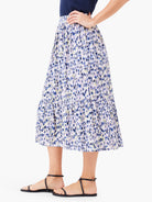 Midi skirt, tiered, white background with blue, purple, and yellow abstract print.