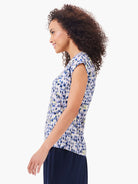 Here's alt text under 125 characters:

V-neck, short-sleeved tank top. Off-white background with abstract blue, purple,...