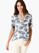 Short-sleeve V-neck tee in white with a gray and teal leaf print.