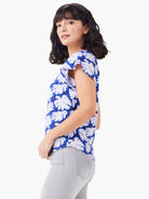 Here's alt text under 125 characters:

Short-sleeve, blue tee with white leaf print. Flutter sleeves.