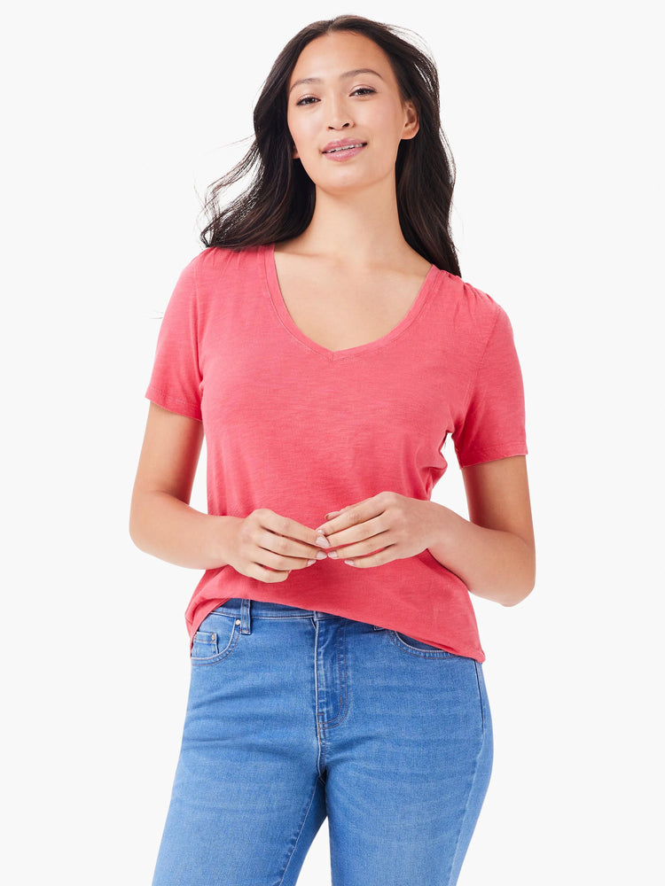 Pink short-sleeved V-neck t-shirt;  model is wearing light blue jeans.