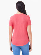 Coral short sleeve tee, back view. Features rounded hem and subtle heathered fabric.