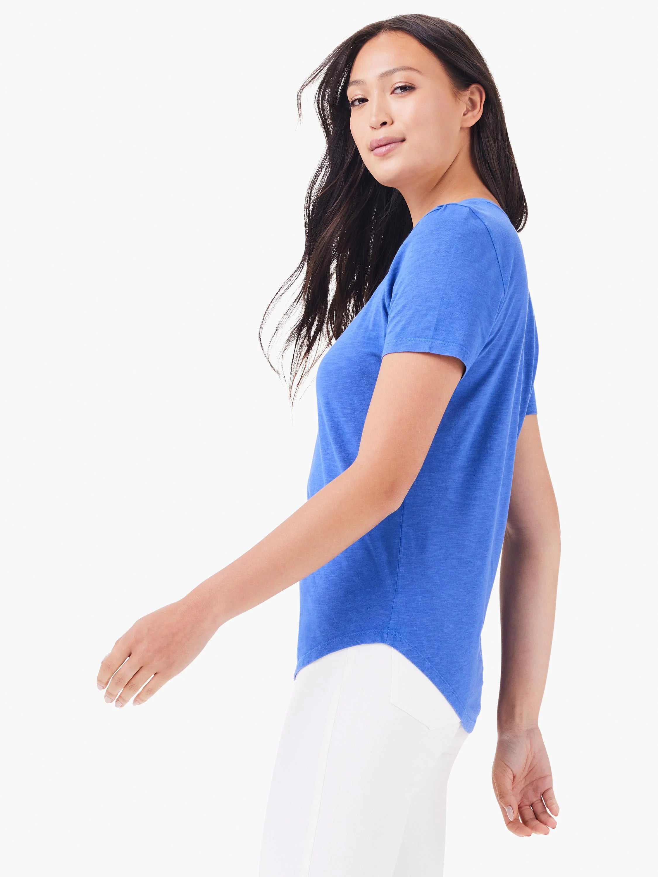 Heather blue short sleeve V-neck tee with a rounded hem, worn by a woman with dark hair.