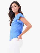 Blue short-sleeve shirt with flutter sleeves; textured fabric.
