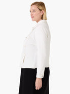 Off-white denim-look jacket with tan contrast stitching. Features a collar, chest flap pockets, side slit pockets, and...