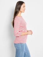 Red and cream horizontal striped 3/4 sleeve boat neck tee on a model.