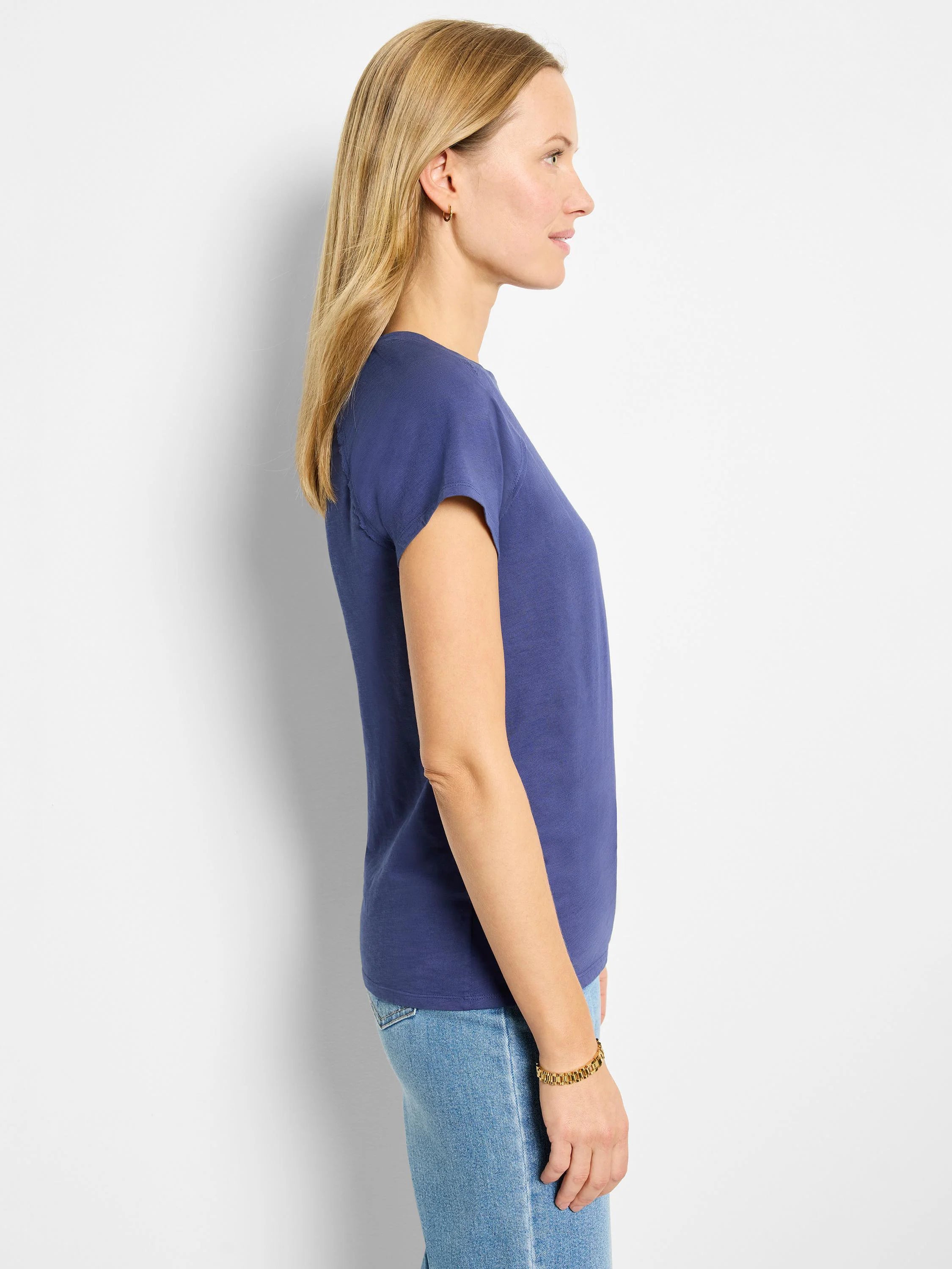 Here's alt text under 125 characters:

"Side view of a dark blue, short-sleeve cotton t-shirt with a crew neck.  The...