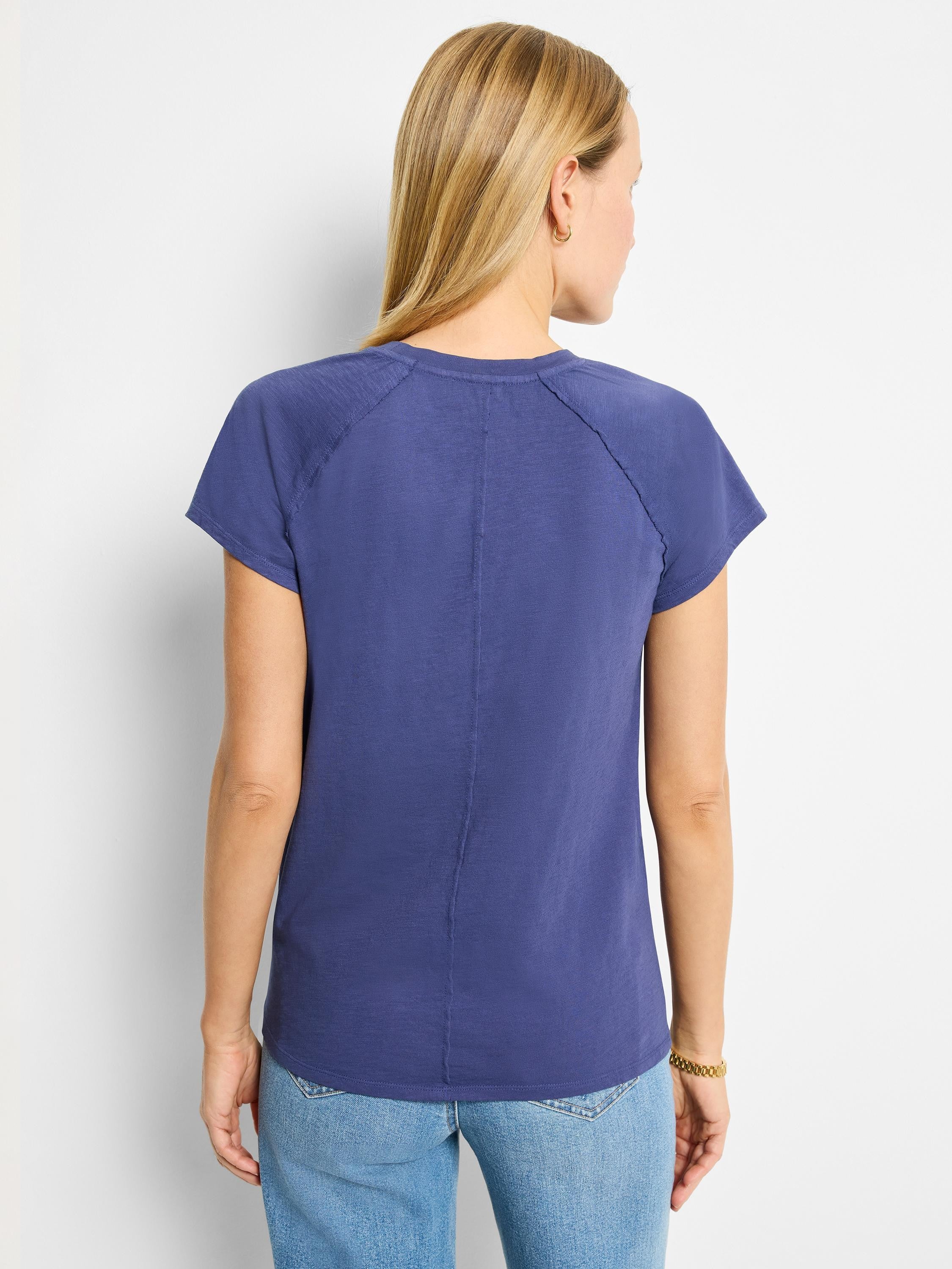 Dark blue, short-sleeve cotton crew neck tee.  Back view shows seamed back and slightly slubbed texture.