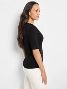 Black elbow-length sleeve shirt with gold buttons on the shoulder.  Side profile view.