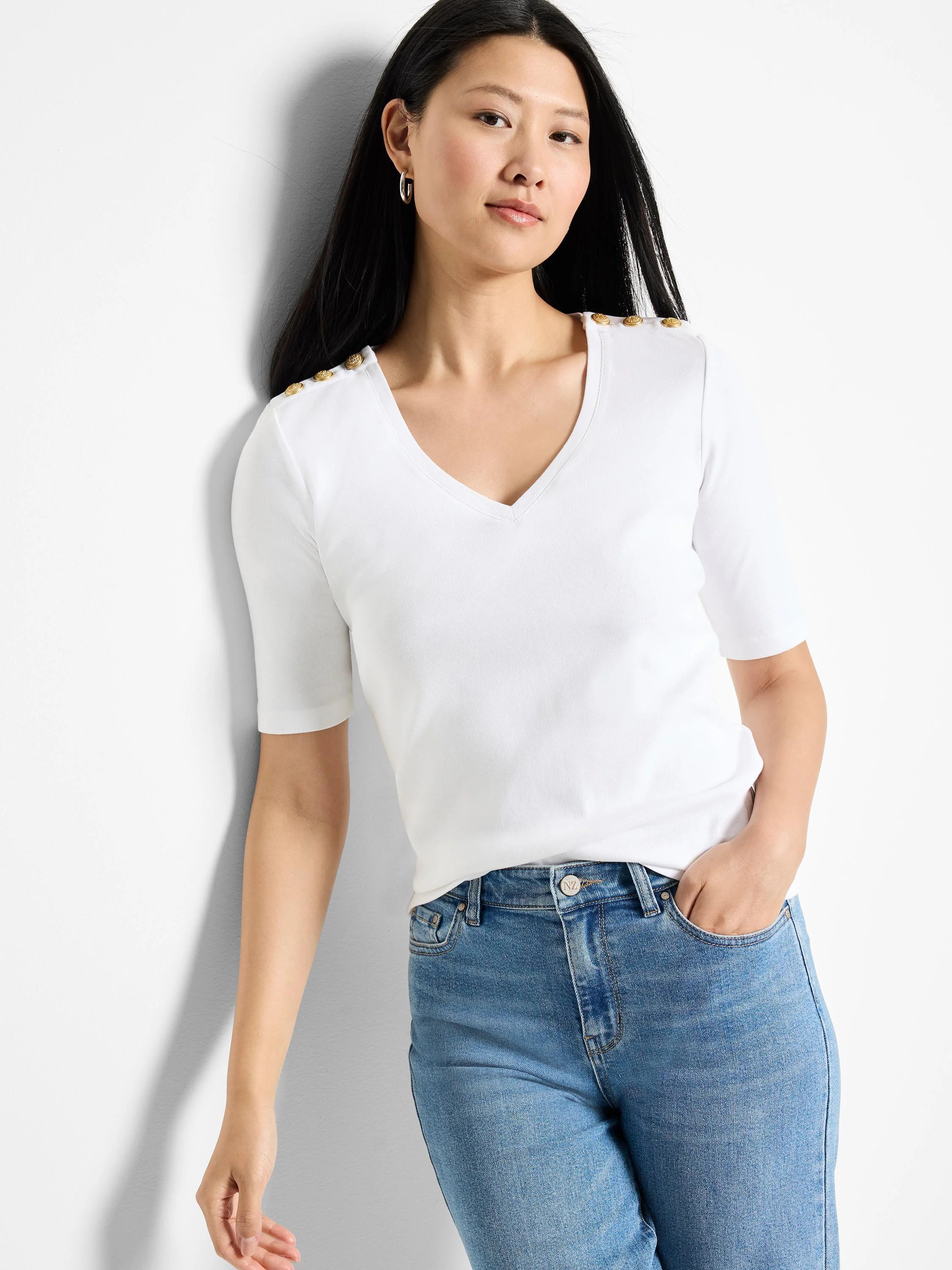 White v-neck, short-sleeve shirt with gold buttons on shoulders.