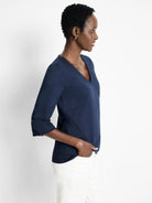 Navy blue 3/4 sleeve v-neck t-shirt.  Neckline and sleeves have frayed edges.