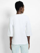 White 3/4 sleeve t-shirt with frayed edges.  Back view.