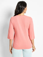 Salmon pink, 3/4 sleeve shirt with frayed edges at neckline and sleeves.  Back view.
