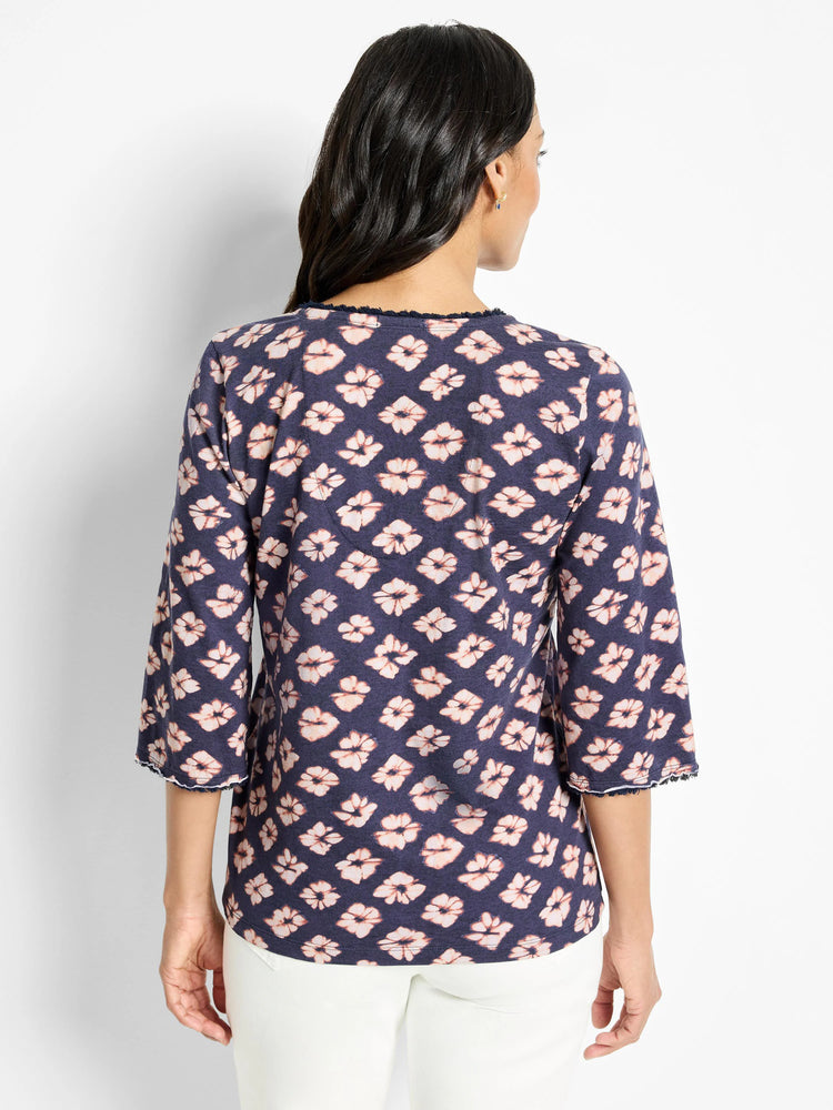 Dark navy 3/4 sleeve shirt with a light peach floral pattern and frayed edges.