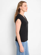 Black V-neck tank with cap sleeves and relaxed fit, worn by a model.