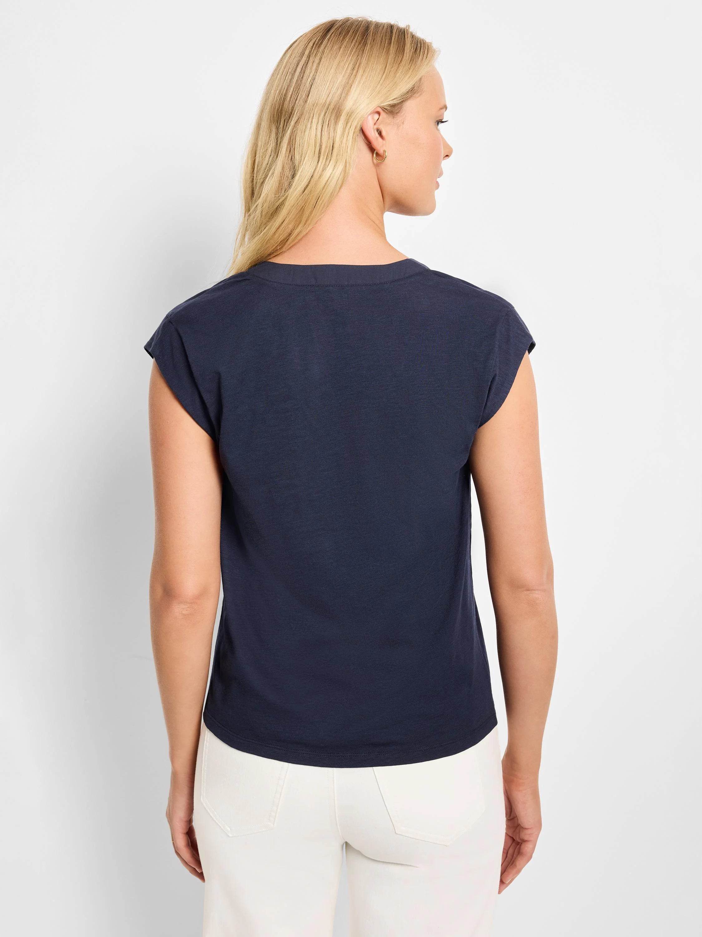 Navy blue tank top with rounded back neckline and cap sleeves, worn by a woman facing away.