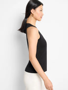 Black sleeveless V-neck tank top; fitted silhouette.