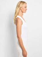 White sleeveless V-neck tank top;  close-fitting.