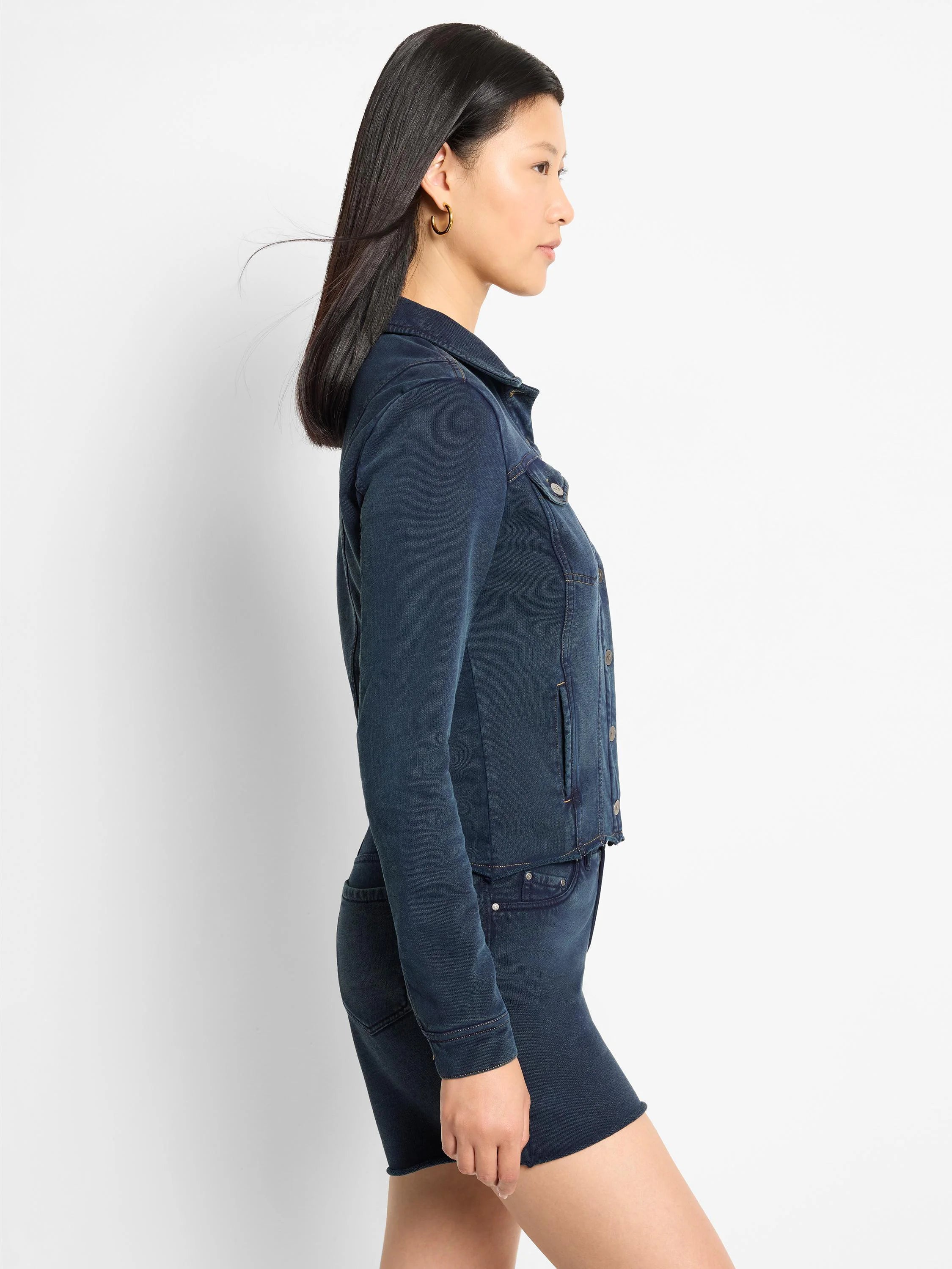 Dark blue collared jacket with a denim look, front buttons, chest pockets, and light brown contrast stitching.