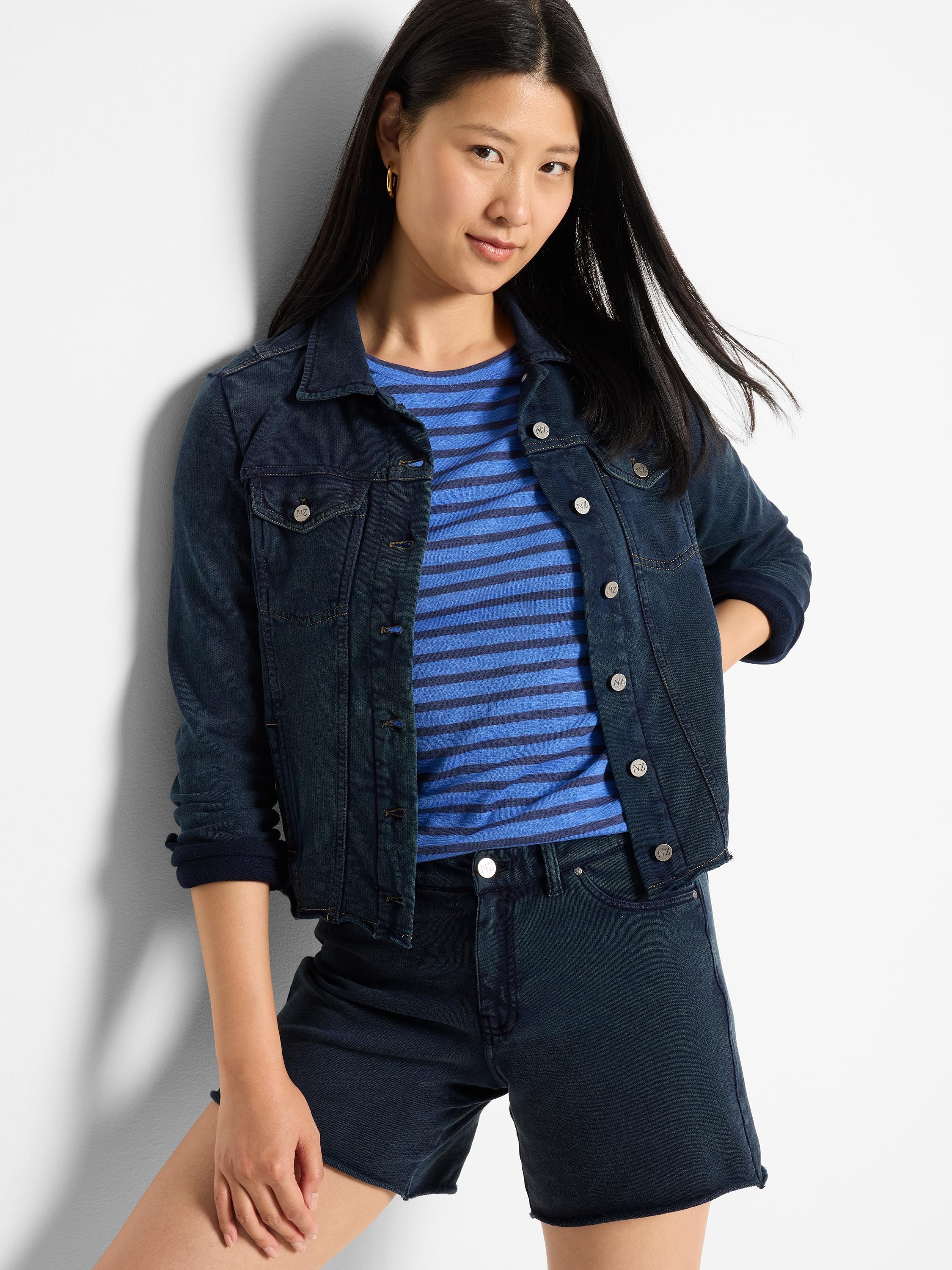 Dark indigo denim-look jacket with silver buttons, flap chest pockets, collar, and tan contrast stitching.