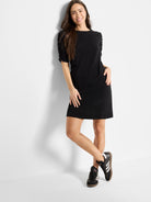 Black mini dress with ruched elbow-length sleeves.  A-line silhouette.
