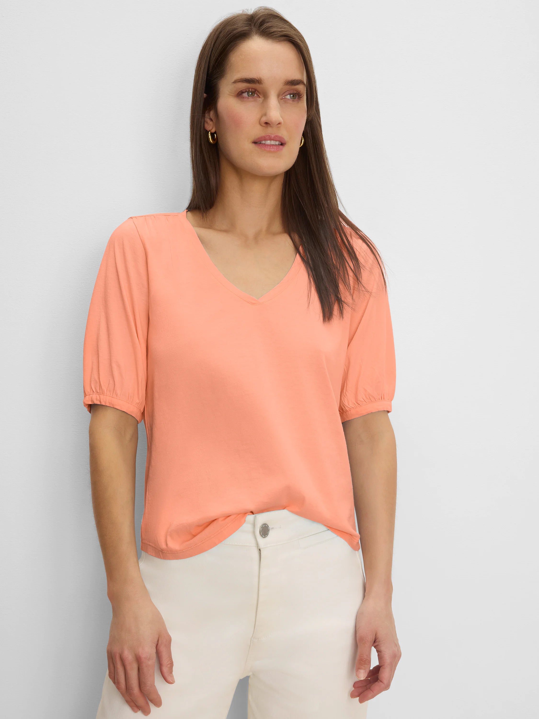 Peach V-neck tee with gathered elbow sleeves.