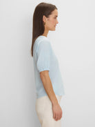 Light blue V-neck tee with elbow-length sleeves and gathered cuffs.