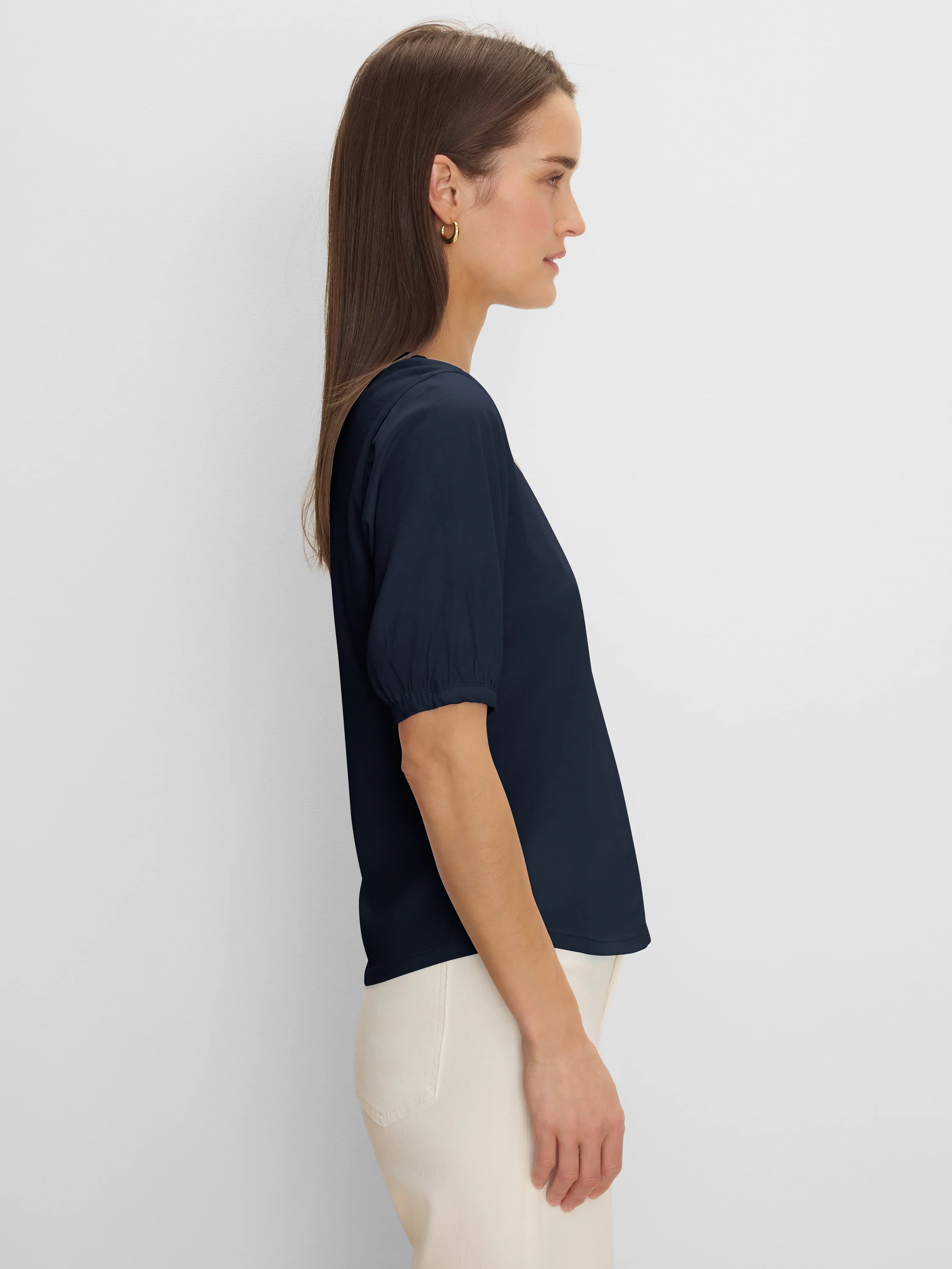 Dark navy V-neck tee with elbow-length sleeves and gathered cuffs, shown on a woman in profile.