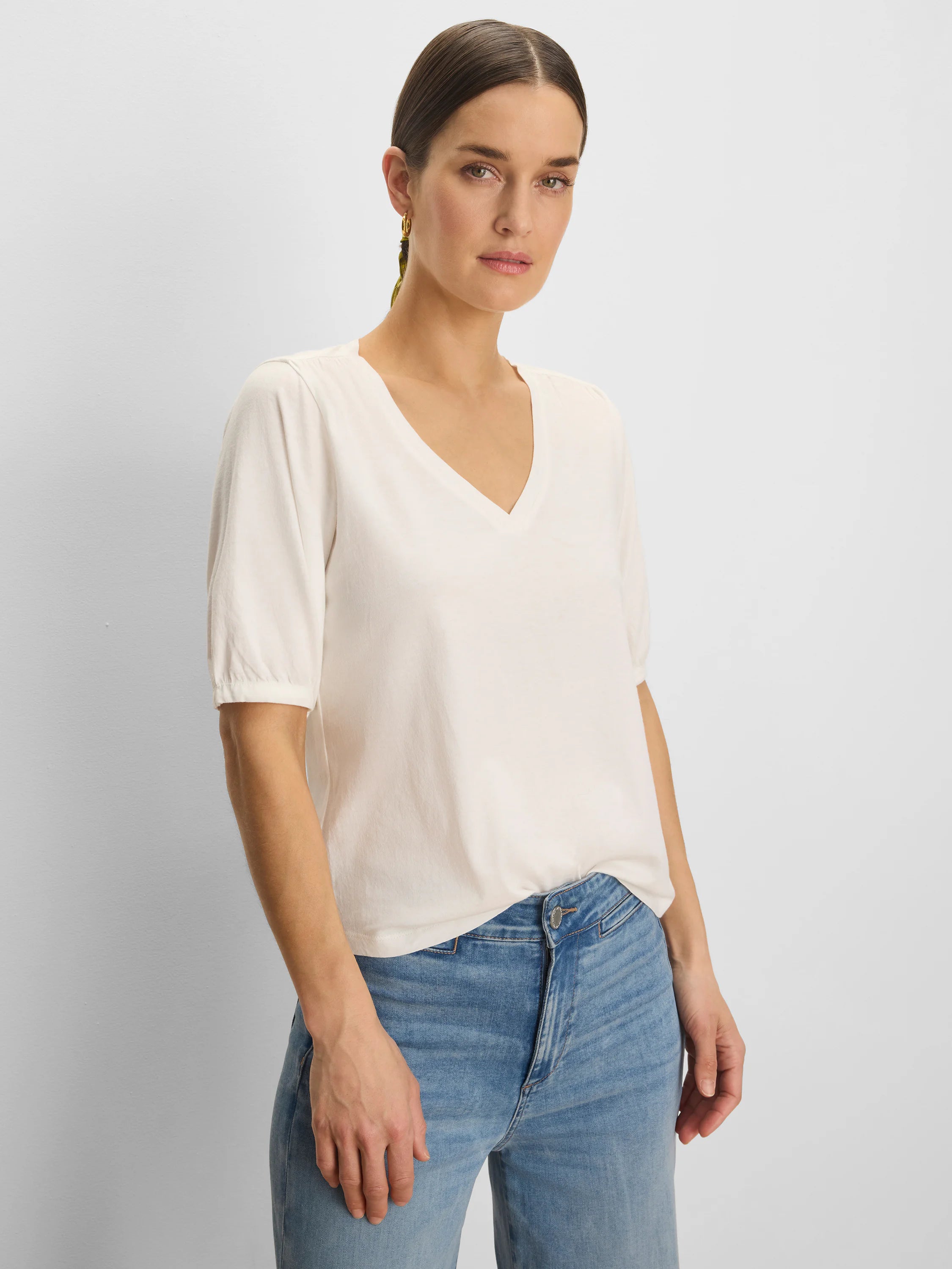 Cream V-neck tee with elbow-length gathered sleeves.