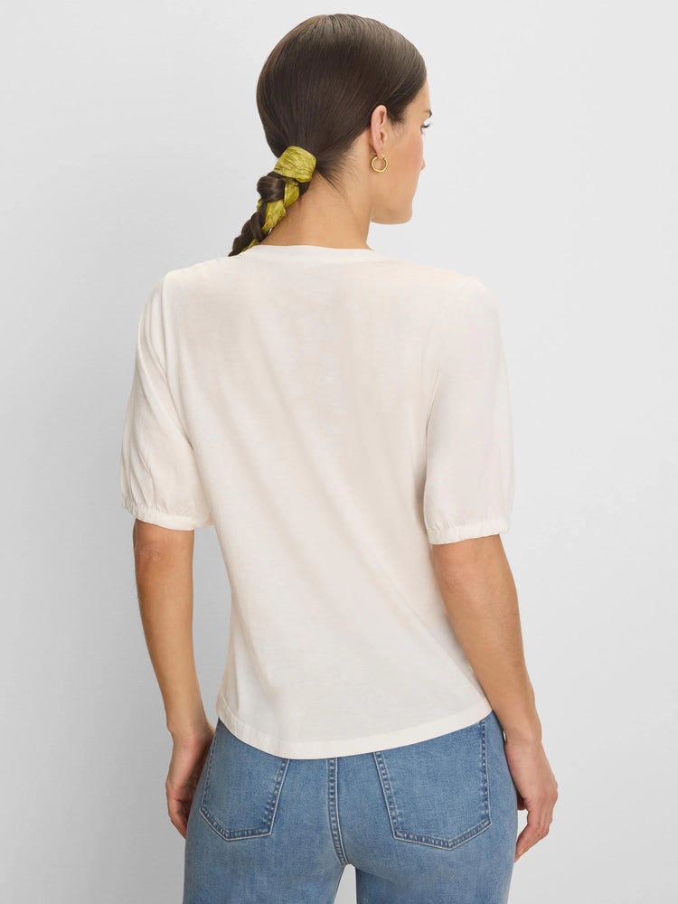 Off-white elbow-sleeve tee, gathered cuffs, seen from the back on a model.