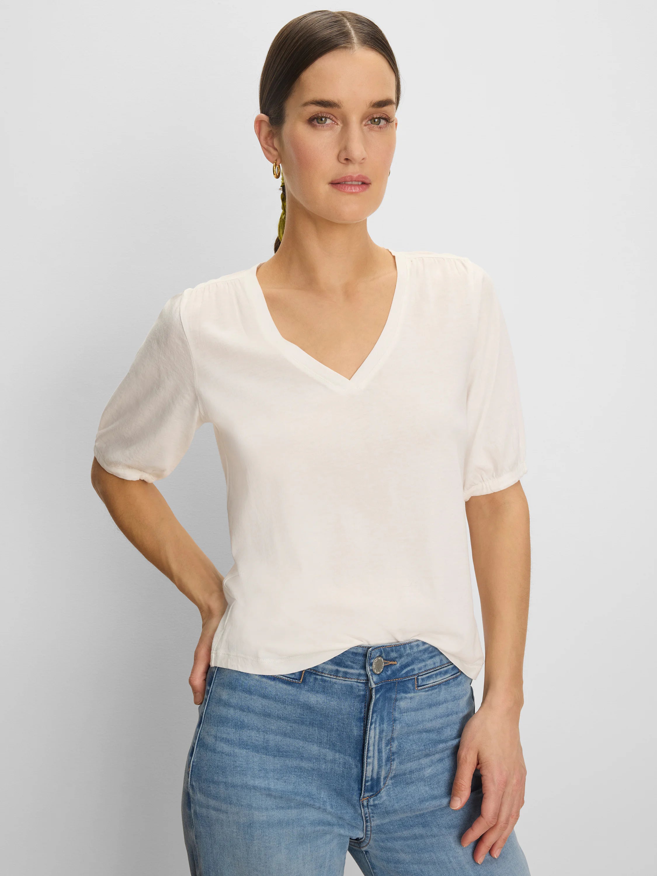Off-white V-neck tee with elbow-length sleeves, slightly gathered at the shoulders and cuffs.