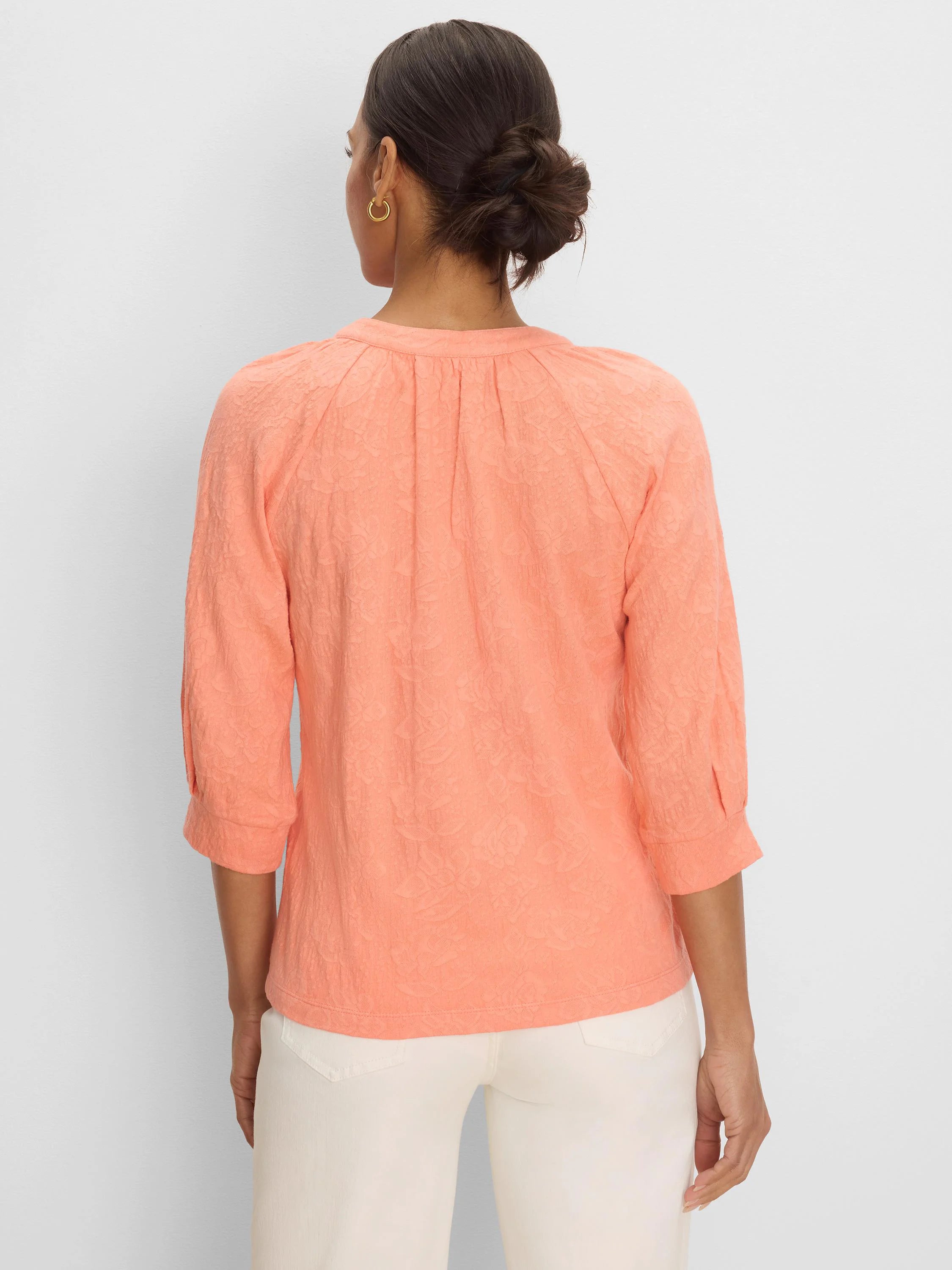 Peach lace knit top with 3/4 sleeves and pleats at the back neckline.