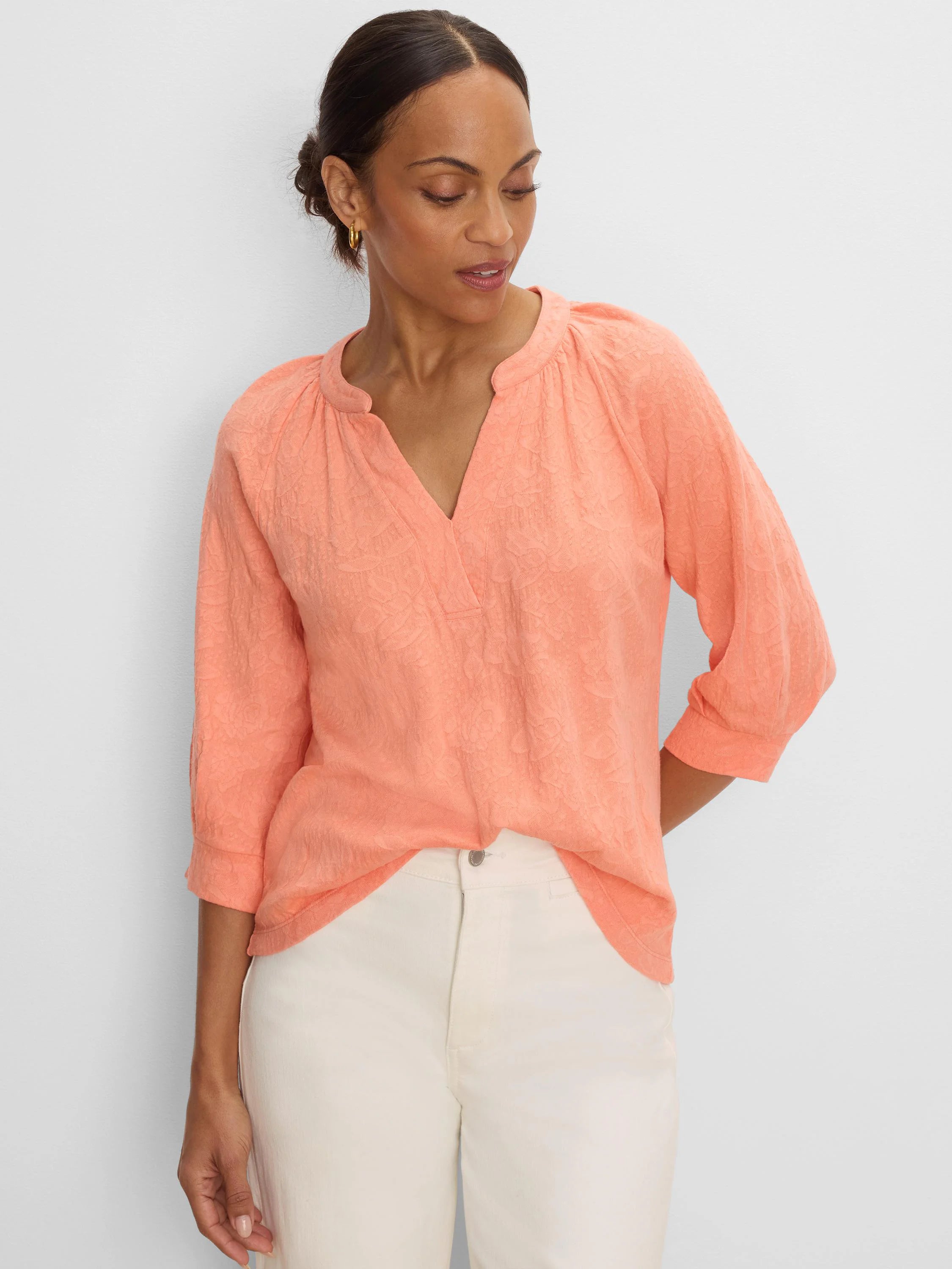 Peach lace knit split neck top with 3/4 sleeves, worn by a model.