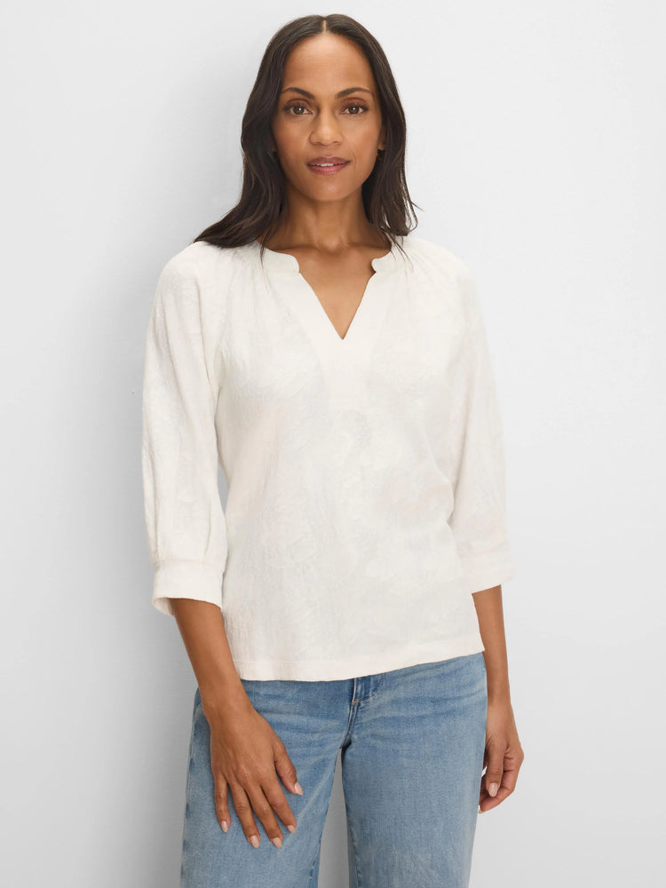 Cream lace knit top with a split V-neck, 3/4 sleeves, and a subtle, textured pattern.