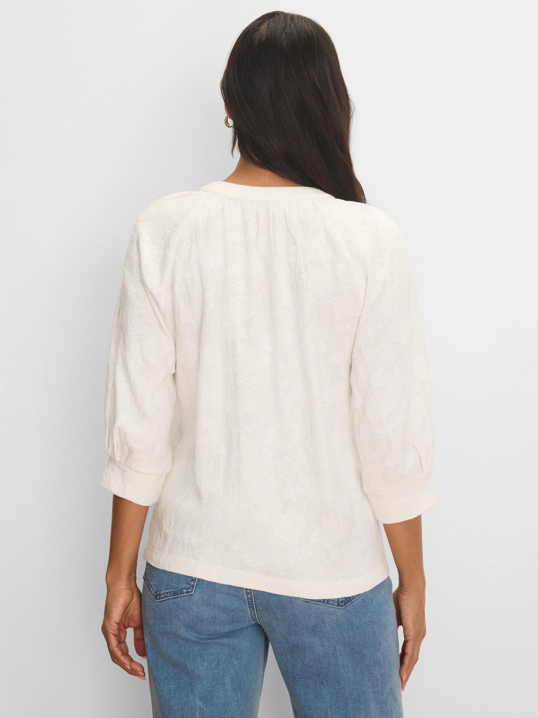 Off-white lace knit top with subtle floral pattern. Back view shows 3/4 cuffed sleeves and gathered neck.