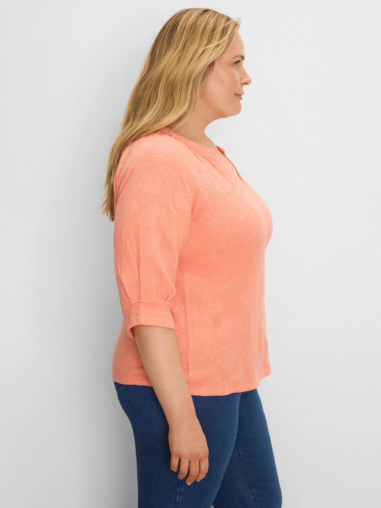 Peach lace knit split neck top with 3/4 sleeves, gathered at the cuff.