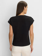Black lace-knit cap sleeve tee with shoulder tabs and buttons, worn on model's back.