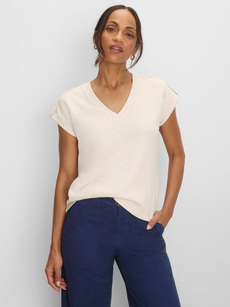 Light cream V-neck tee with subtle geometric lace knit texture and rolled cap sleeves.