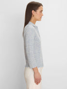 Light blue and white spacedye knit polo with elbow sleeves and scalloped cuffs and hem.