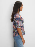 Navy V-neck tee with elbow sleeves, a multicolor check pattern in pink, light blue, and green.