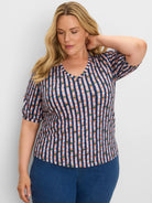 Elbow-sleeve V-neck tee with vertical dark blue stripes intersected by coral, light blue, & green horizontal stripes.