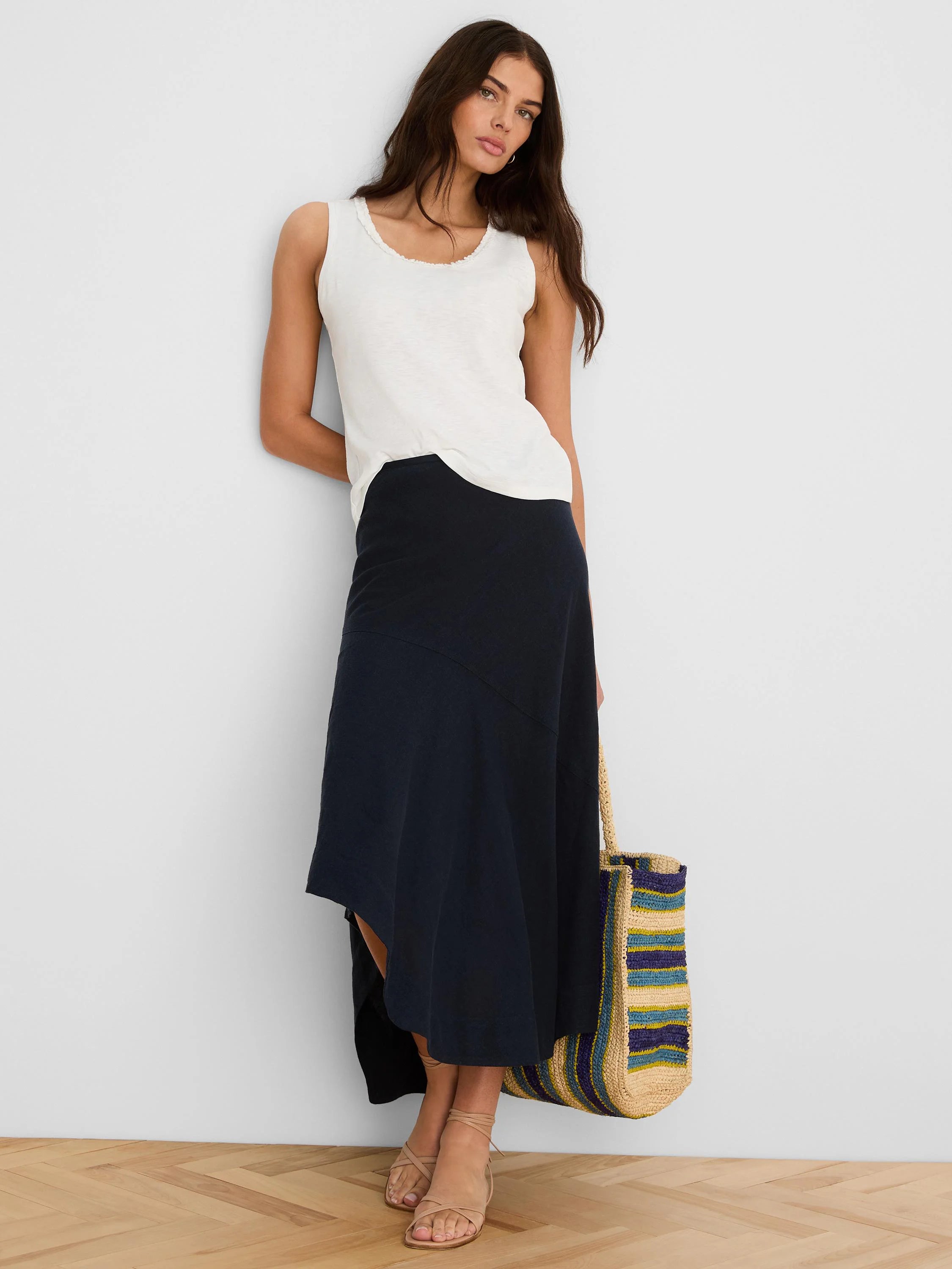 Off-white cotton slub tank top with a ruffled neckline, shown modeled.