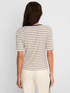 Back view of a cream tee with navy horizontal stripes and elbow-length sleeves.