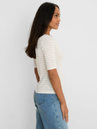 Cream elbow sleeve tee with light brown stripes and a notched neckline.