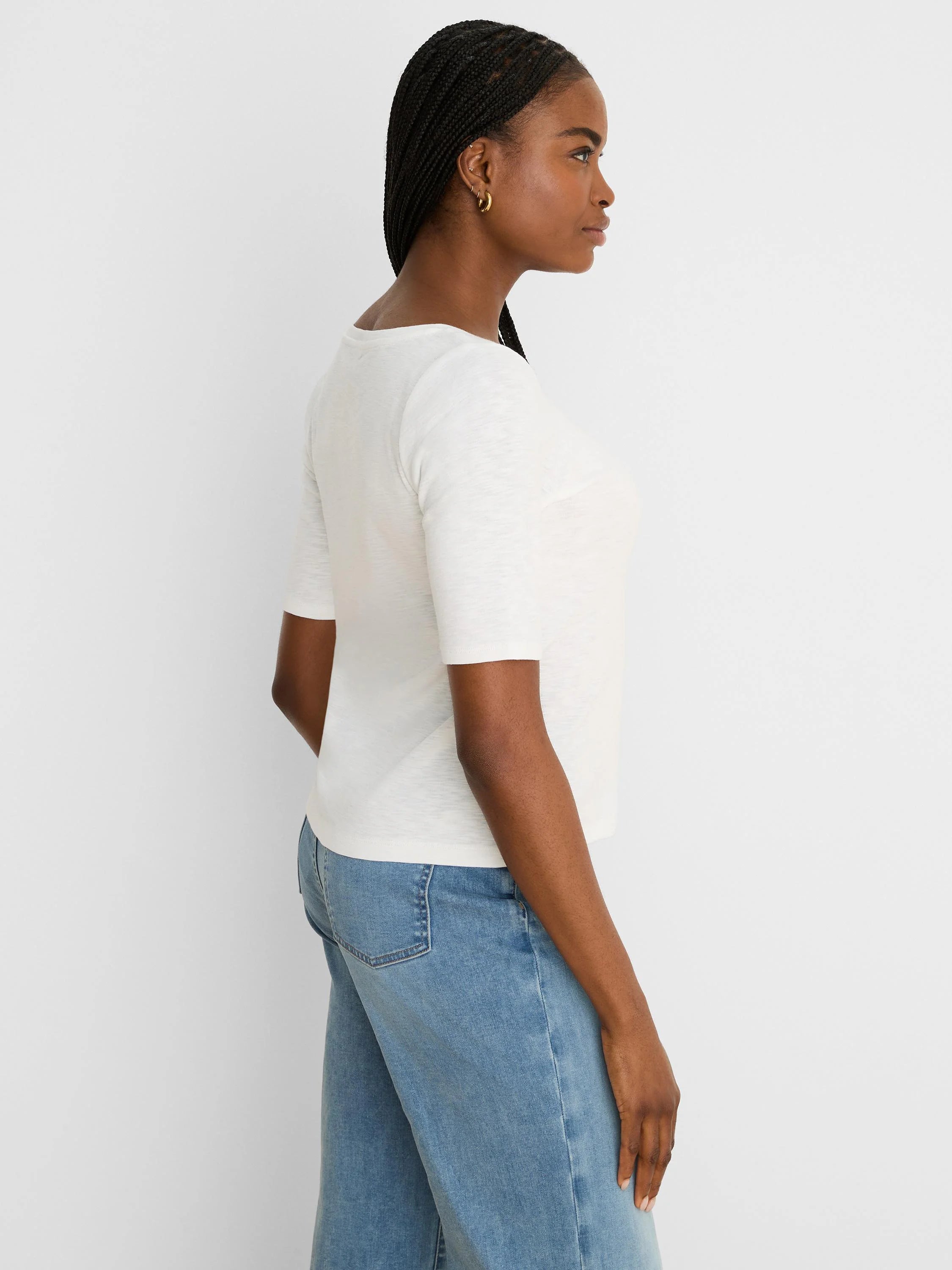 Off-white elbow-sleeve tee with notch neckline and textured fabric.