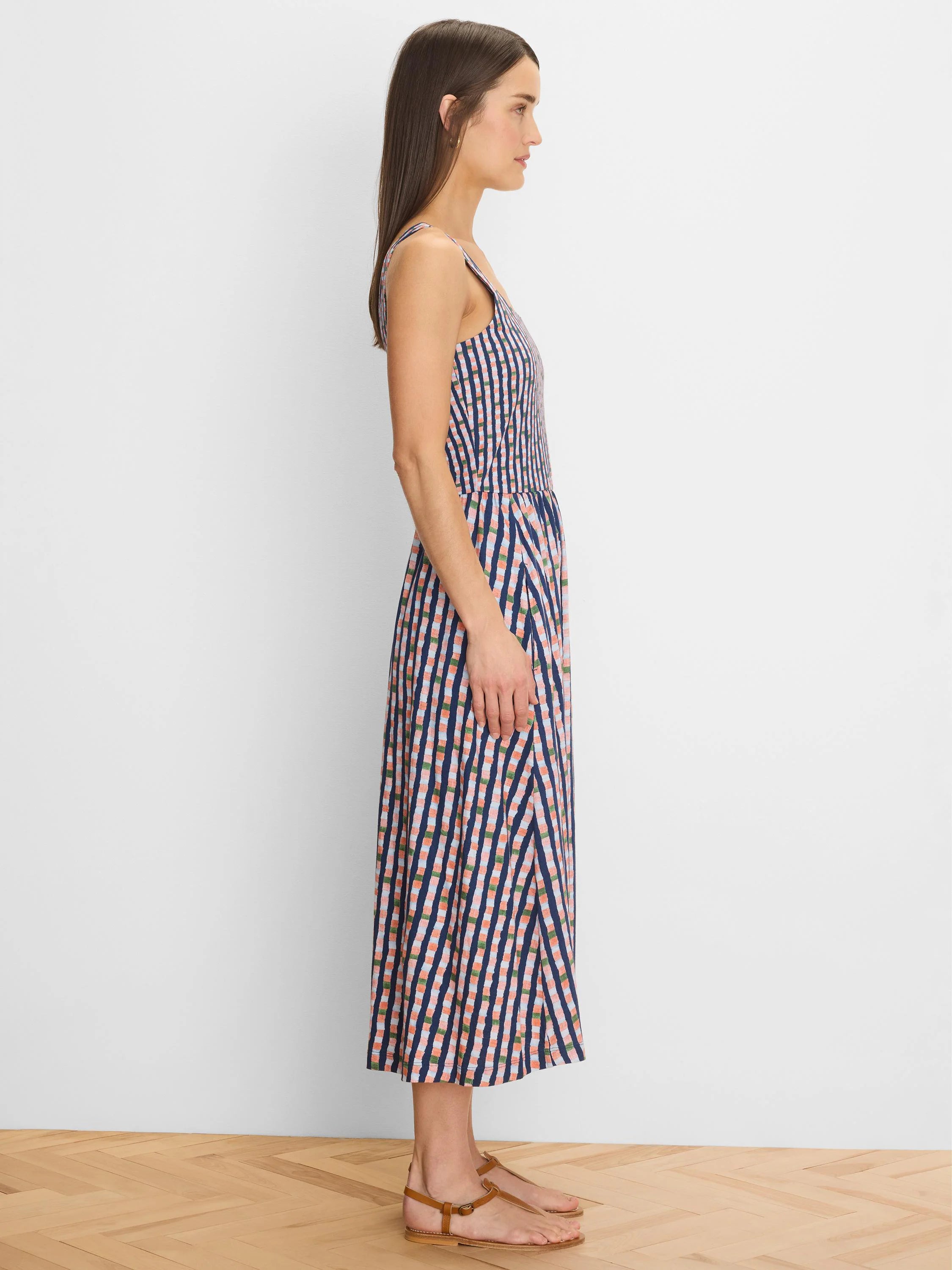 Midi dress with thin straps, navy blue base with coral, light blue & green check pattern.
