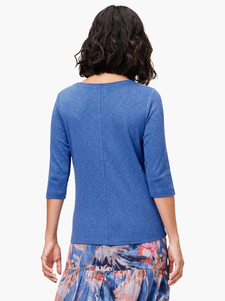 Blue heathered 3/4 sleeve boat neck tee with a vertical seam down the back, worn by a model seen from behind.